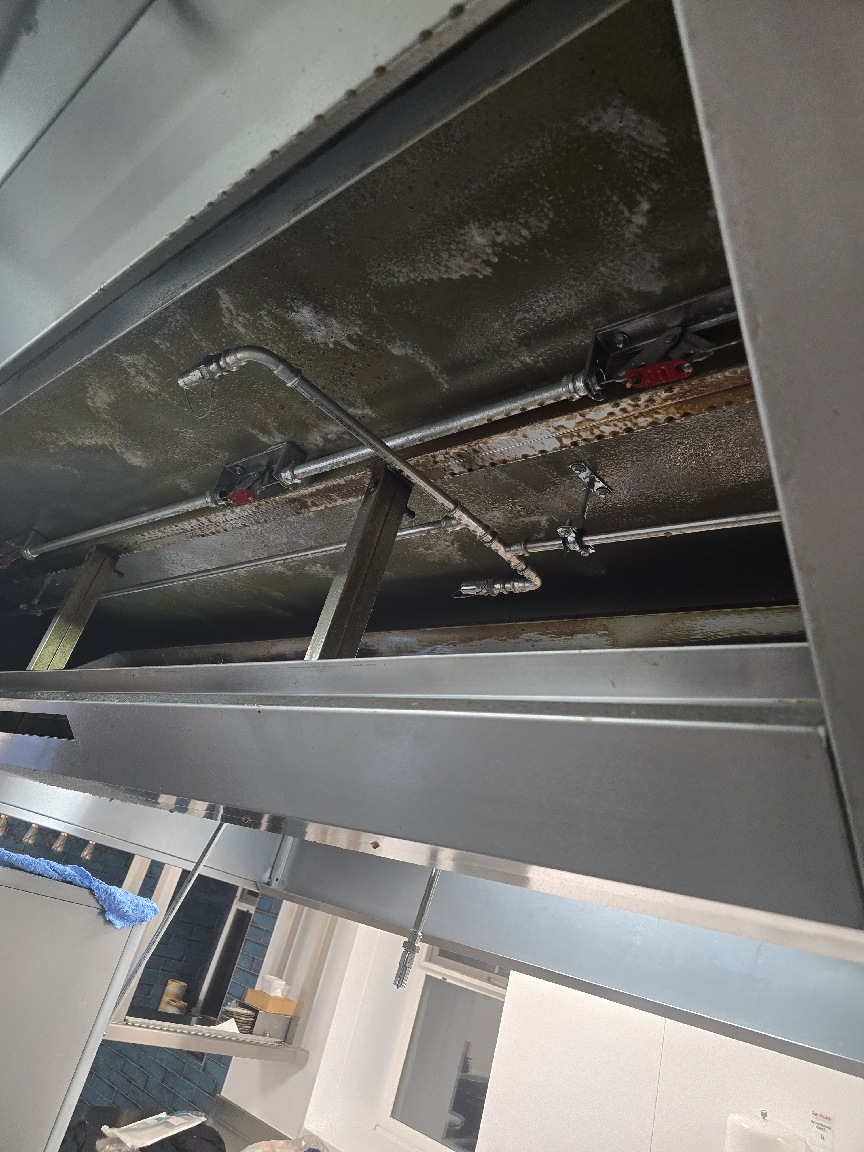 Canopy with grease residue on pipework - before cleaning